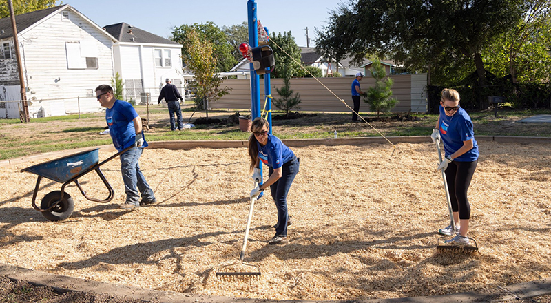 team raking mulch