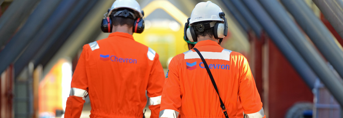 Two Chevron contractors walking through a facility